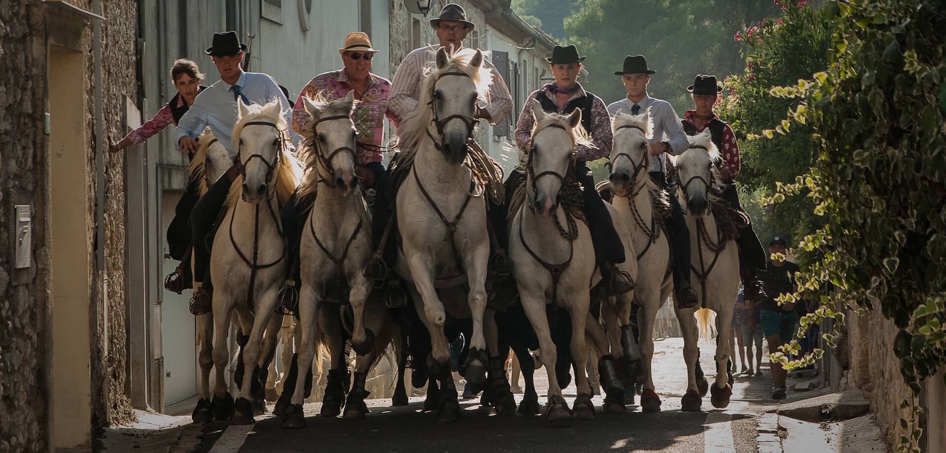 Caballos y jinetes en un callejón estrecho
